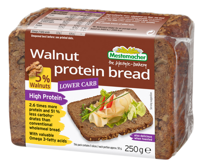 Packaged loaf of walnut protein bread with Mestmacher branding on a white background